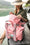 Load image into Gallery viewer, Woman by the water holding beach tote with multiple pouches that are water proof and easy to clean. #color_rose
